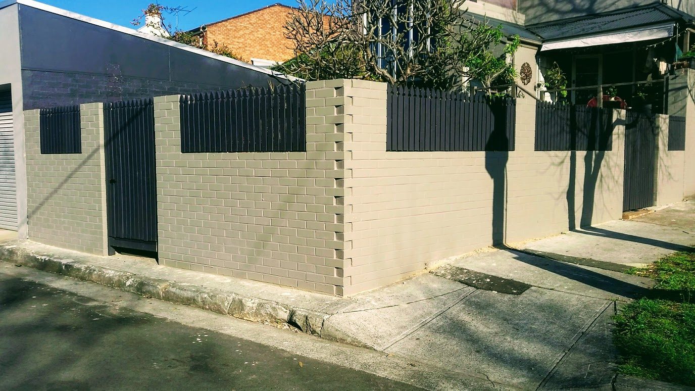 Painted brick fence with pickets