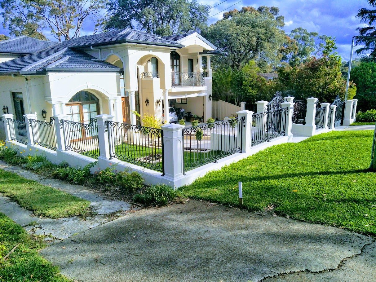 Cast stone piers with wrought iron gates and infills — North Shore